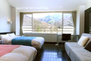 Postel nebo postele na pokoji v ubytování Sora no Mori Hotel Hanagori