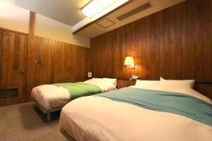 Postel nebo postele na pokoji v ubytování Sora no Mori Hotel Hanagori