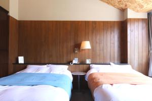 Postel nebo postele na pokoji v ubytování Sora no Mori Hotel Hanagori