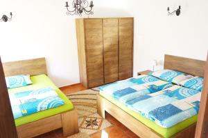a bedroom with two beds and a dresser at Apartment Marta in Lipno nad Vltavou