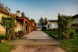 una pasarela que conduce a una casa con entrada en Complejo Las Calandrias en Sierra de la Ventana