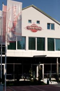 a building with a sign for a louis hotel at Hotel Luka's in Berane