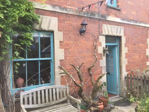 a bench sitting in front of a brick building at Moon in the Apple Tree in Glastonbury