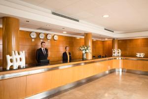 two men are standing in a waiting room at htop Pineda Palace SPA 4Sup - Bliss - Adults Only Plus 18 in Pineda de Mar +40 photos
