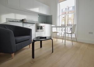 a living room with a couch and a table at Kings Cross Serviced Apartments by Concept Apartments in London