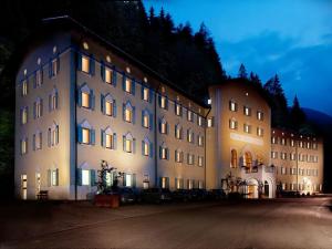 a large building is lit up at night at Grand Hotel Rabbi in Bagni di Rabbi