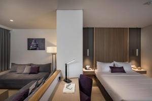 Posteľ alebo postele v izbe v ubytovaní Trianon Luxury Apartments & Suites
