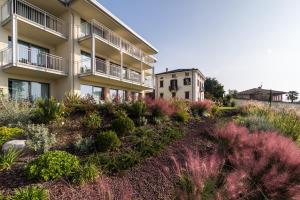 an apartment building with plants in front of it at Hotel Domaso in Domaso