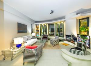 a living room filled with furniture and a fireplace at Kallimarmaro Residence in Athens