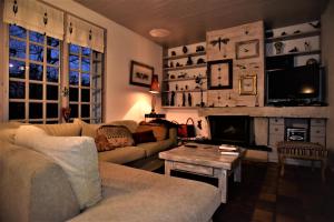 a living room with a couch and a fireplace at Maison Le Boubioz in Ugine