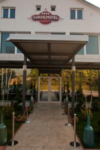 an entrance to a hotel with a large building at Hotel Luka's in Berane