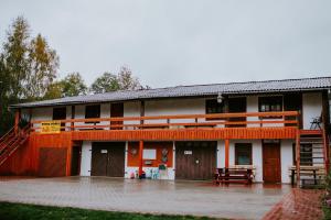 a building with orange and white at Viesu nams Pupa in Kuldīga