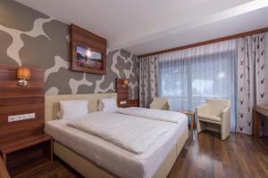 Postel nebo postele na pokoji v ubytování Genusshotel Almrausch
