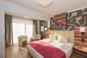 Postel nebo postele na pokoji v ubytování Genusshotel Almrausch