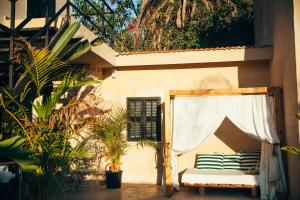 a patio with a chair and a window and plants at Hotel Anilevich Mansion in Beer Sheva