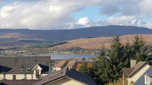 a view of a town with a lake and mountains at Berkeley House in Fort William