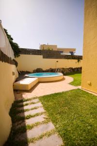 a swimming pool in the backyard of a house at Deluxe Apartment. 50 meters Beach in San Agustin