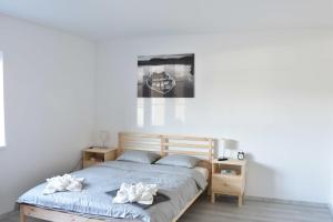 a bedroom with a bed with two white towels on it at Apartmany U Letiste in Pardubice