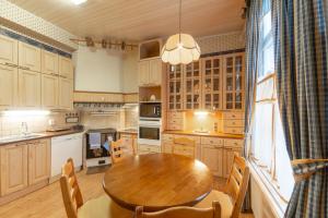 a large kitchen with a wooden table and chairs at Wanha Kartano in Kokkola