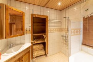 a bathroom with a tub and a sink and a shower at Wanha Kartano in Kokkola +52 photos