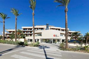 a building with palm trees in front of it at Exe Estepona Thalasso & Spa- Adults Only in Estepona