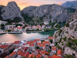 an aerial view of a town on a river with mountains at Apartment MARI in Ostrvica