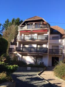 a large white building with balconies on top of it at Appartement Adélaïde in Le Hohwald