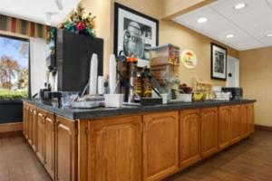 a kitchen with a large counter with a counter top at Super 8 by Wyndham Oxford in Oxford