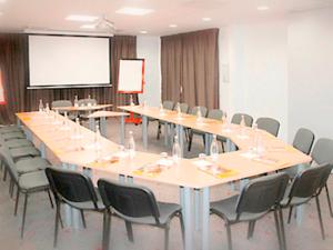 a large conference room with a large table and chairs at ibis Istres Trigance in Istres