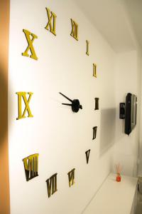 a wall clock with gold and black clocks on it at Apartamento Botavara in Málaga