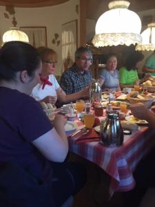 a group of people sitting around a table eating at Landgasthaus Waldschänke in Emmendingen