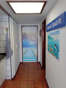 a hallway with a painting of a pier at Casa do Espadarte in Sesimbra