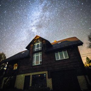 a house with a starry sky above it at Pod Bieszczadem in Jaśliska