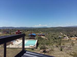 a view from the balcony of a house with a swimming pool at Estancia de Campo in Estancia Vieja
