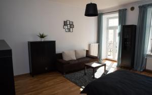 a living room with a bed and a couch at EASY RENT Apartments - Konopnicka 11, Centrum 24h Check-in in Lublin
