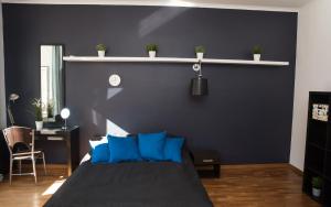 a bedroom with a bed with blue pillows at EASY RENT Apartments - Konopnicka 11 in Lublin