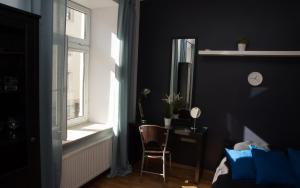 a bedroom with a chair next to a window at EASY RENT Apartments - Konopnicka 11, Centrum 24h Check-in in Lublin +26 photos