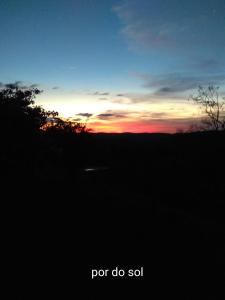 a sunset in a field with the words for do soil at Chácara Áquila in São Roque