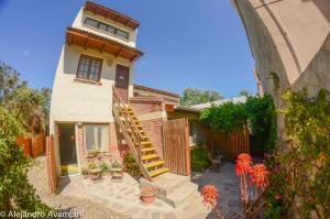 a house with a spiral staircase in front of it at De Luna in Puerto Pirámides
