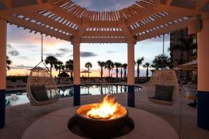 a fire pit in the middle of a patio with a pool at Sirata Beach Resort in St. Pete Beach