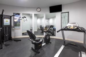 a gym with two treadmills and two exercise bikes at Baymont by Wyndham Houston Hobby Airport in Houston