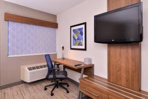 a room with a desk with a computer and a tv at Holiday Inn Express Walnut Creek by IHG in Walnut Creek