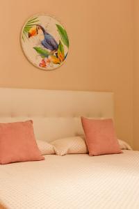 a bed with two pillows and a clock on the wall at JAVICENTER in Arrecife