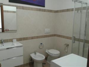 a bathroom with a toilet and a sink and a shower at CASETTA RELAX A SUTRI in Sutri