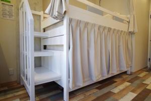 Postel nebo postele na pokoji v ubytování Cinnamon Guesthouse Dogo