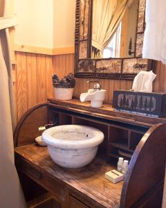 a bathroom with a bowl sink and a mirror at Wayward Cottage in Pisgah