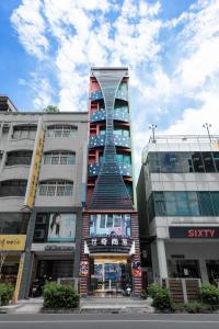 a tall building with a spiral tower in a city at Shichi Hotel in Kaohsiung
