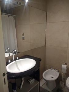 a bathroom with a sink and a toilet at Departamentos Patagonia in San Carlos de Bariloche +9 photos
