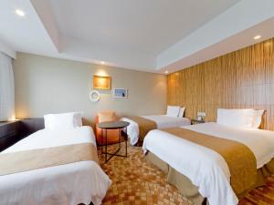 Giường trong phòng chung tại Hotel Universal Port