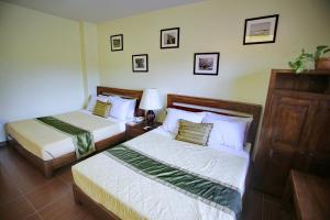 En eller flere senge i et værelse på Villa Elita